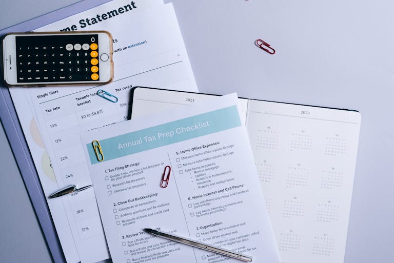 Flat lay of a tax preparation checklist, calculator, and financial documents on a desk for optimized bookkeeping systems