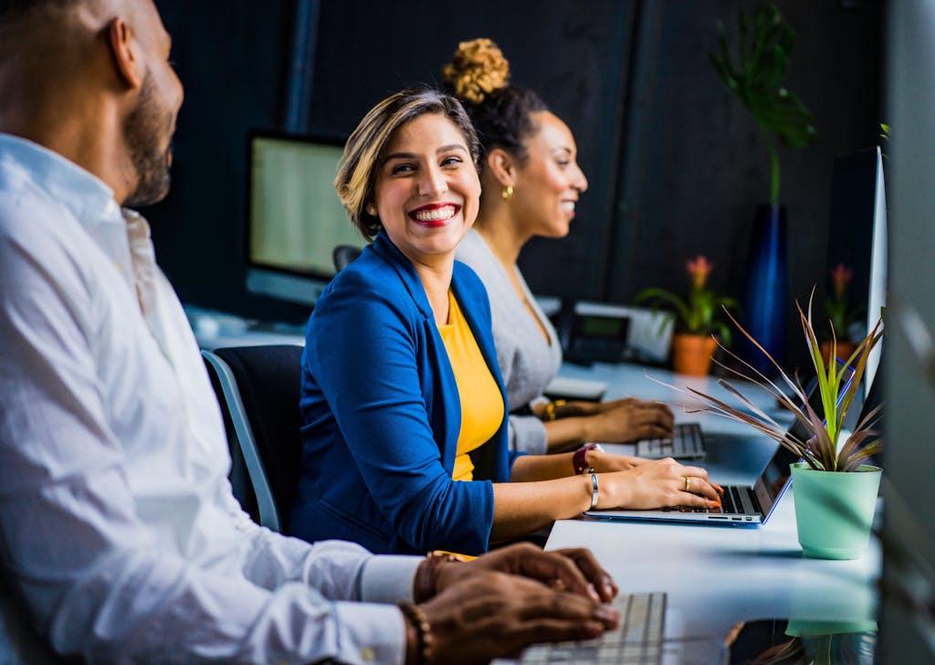 smiling woman in an office representing StreamlineYour.work’s Refund and Returns Policy and customer support
